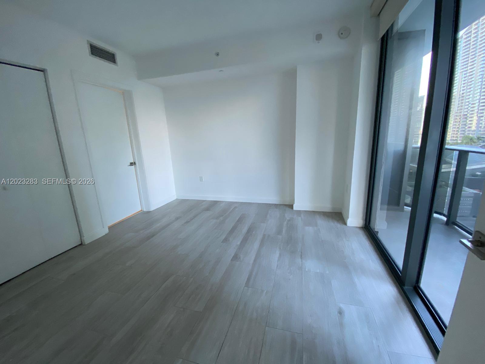 55 Southwest 9th Street, Unit 1503 Miami, FL 33130 - Photo 7 of 11 a view of a hallway with wooden floor