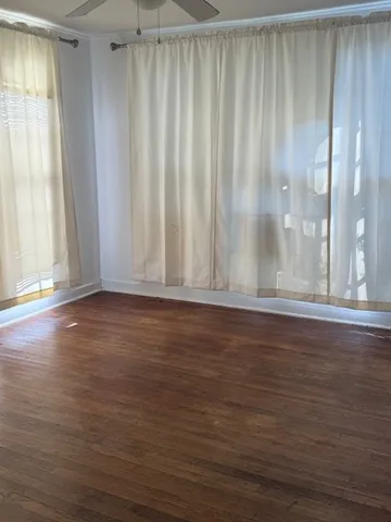 a view of wooden floor and windows in a room