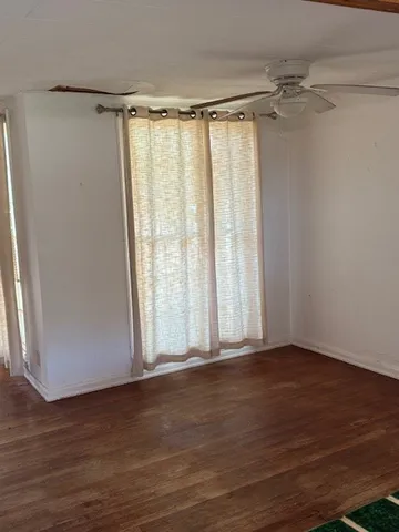 a view of a room with wooden floor and walls