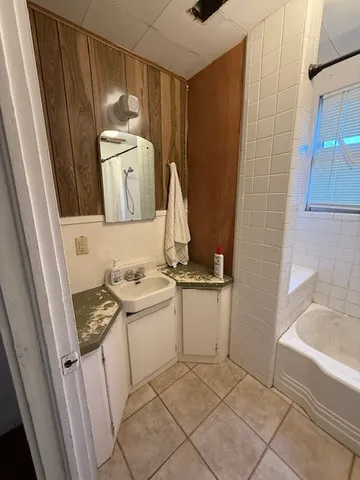a bathroom with a sink toilet and tub