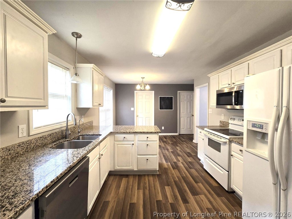 5527 Rising Ridge Drive Hope Mills, NC 28348 - Photo 12 of 35 a kitchen with stainless steel appliances granite countertop a sink stove and refrigerator