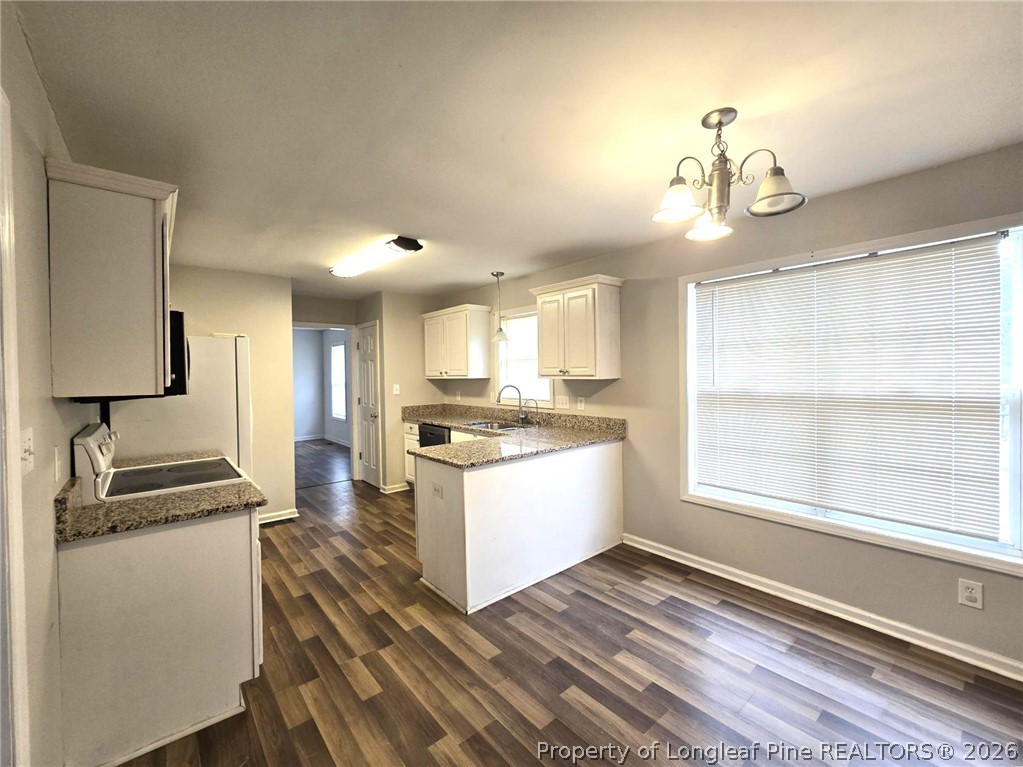 5527 Rising Ridge Drive Hope Mills, NC 28348 - Photo 17 of 35 a kitchen with kitchen island stainless steel appliances a counter space and wooden floor