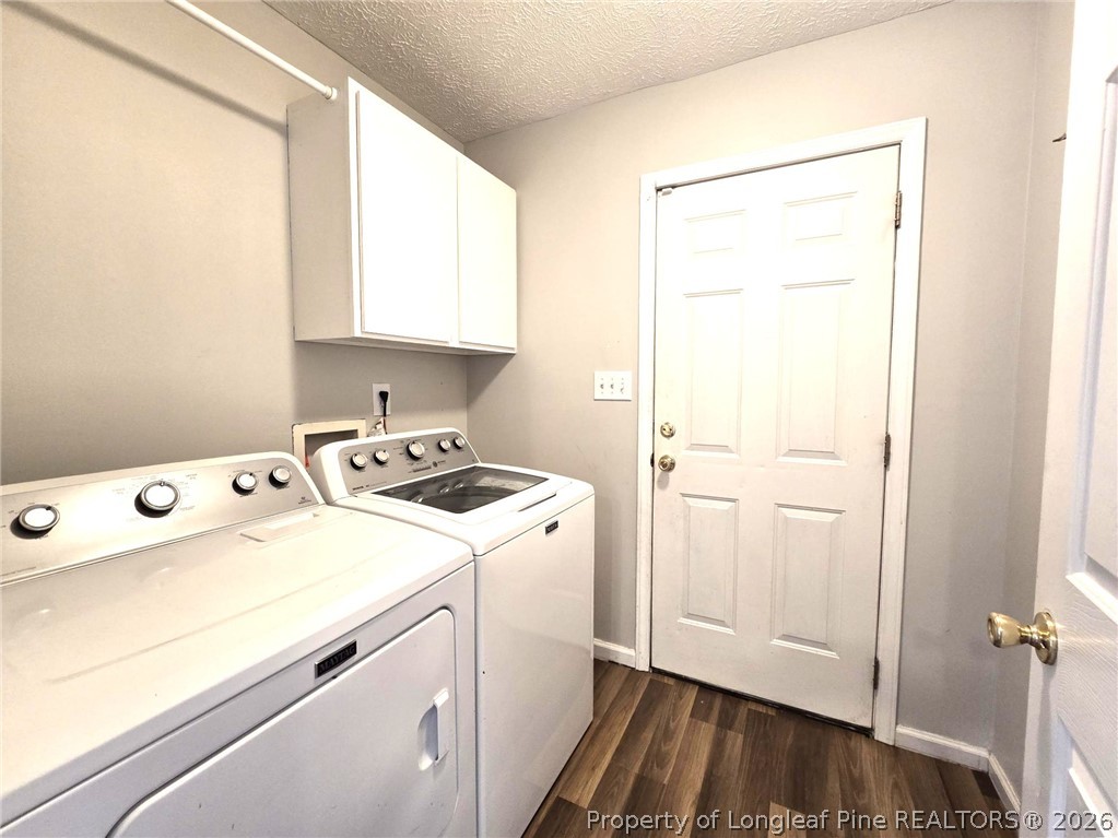 5527 Rising Ridge Drive Hope Mills, NC 28348 - Photo 19 of 35 a view of washer and dryer with kitchen in the background