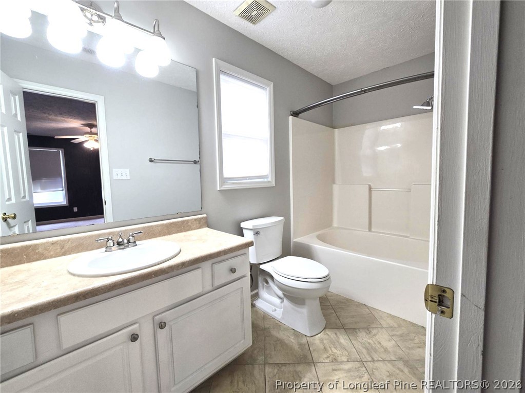 5527 Rising Ridge Drive Hope Mills, NC 28348 - Photo 28 of 35 a bathroom with a sink a toilet a mirror and shower
