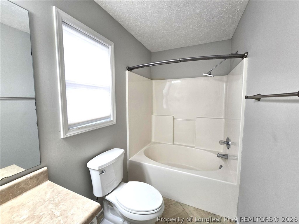 5527 Rising Ridge Drive Hope Mills, NC 28348 - Photo 30 of 35 a white toilet sitting next to a bath tub