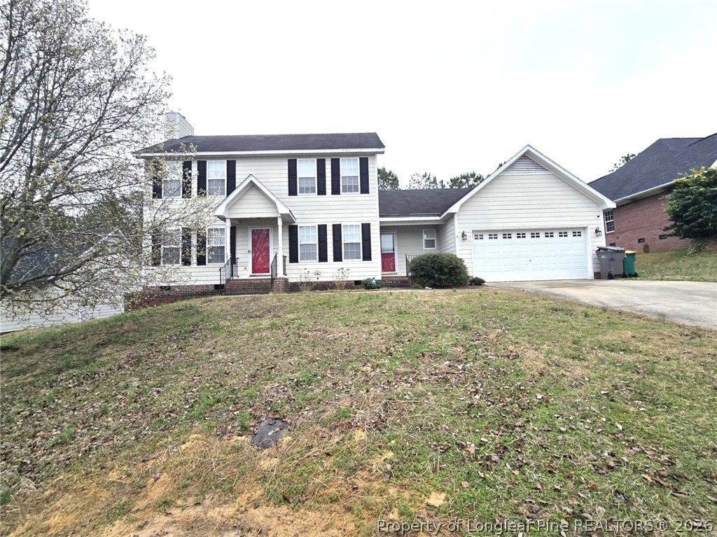 5527 Rising Ridge Drive Hope Mills, NC 28348 - Photo 3 of 35 a front view of a house with a yard and garage