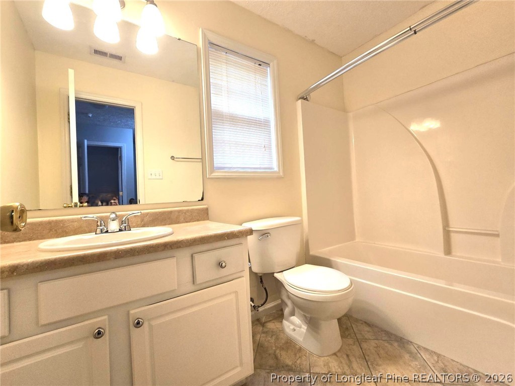 5527 Rising Ridge Drive Hope Mills, NC 28348 - Photo 33 of 35 a bathroom with a sink a toilet and a bathtub