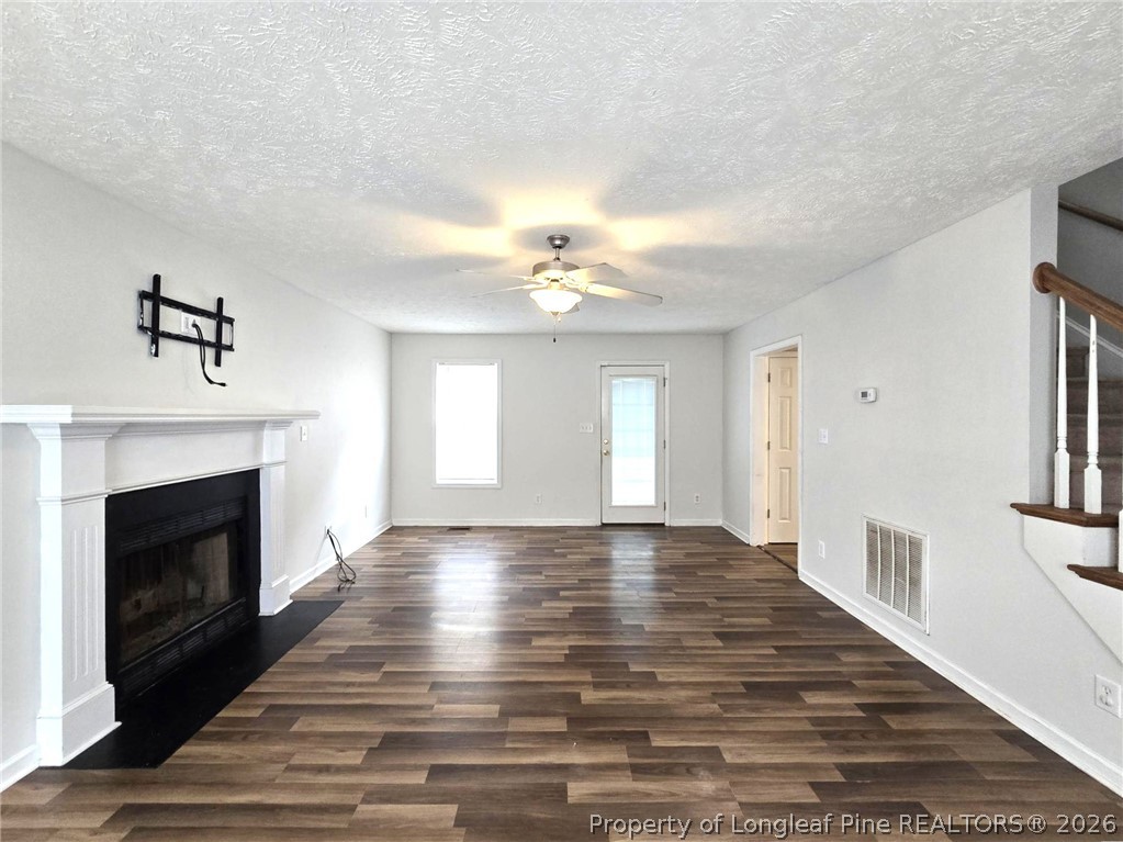 5527 Rising Ridge Drive Hope Mills, NC 28348 - Photo 6 of 35 a view of an empty room with a fireplace and a window