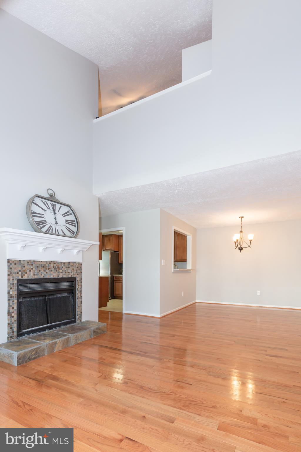 2233 Hunter's Run Drive Reston, VA 20191 - Photo 13 of 50 a view of empty room with wooden floor and fireplace