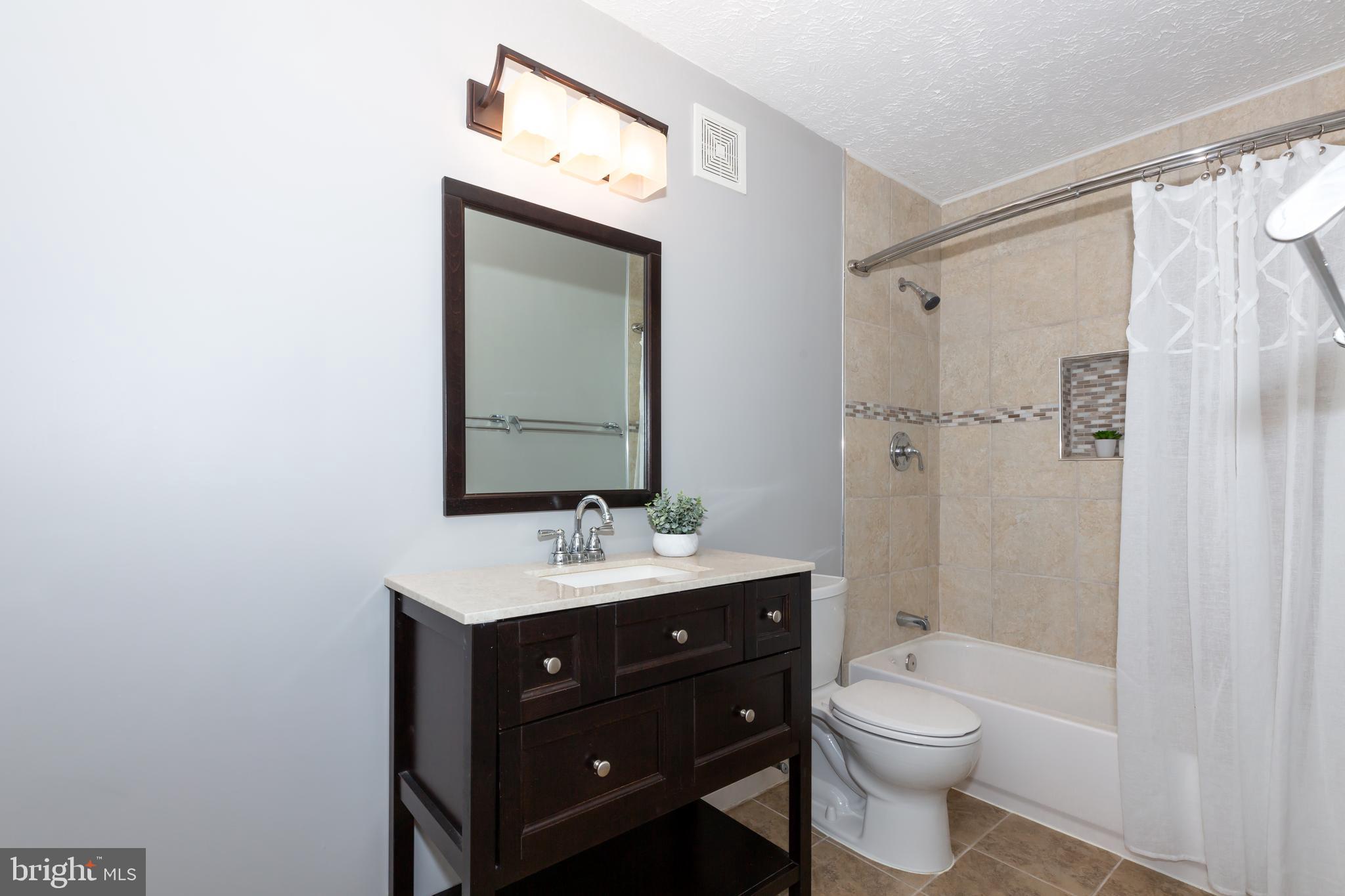 2233 Hunter's Run Drive Reston, VA 20191 - Photo 17 of 50 a bathroom with a toilet sink vanity granite and shower