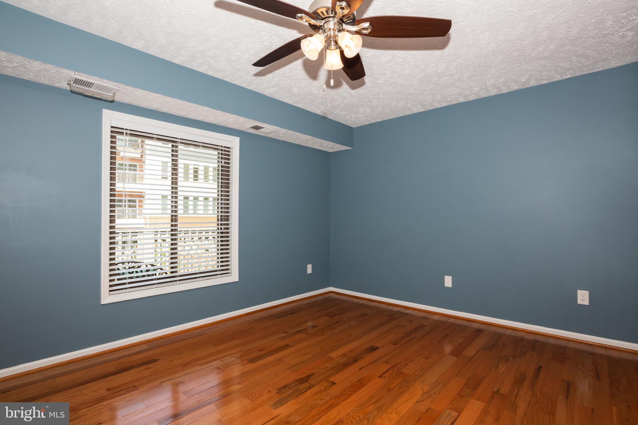 2233 Hunter's Run Drive Reston, VA 20191 - Photo 19 of 50 a view of an empty room with window and wooden floor