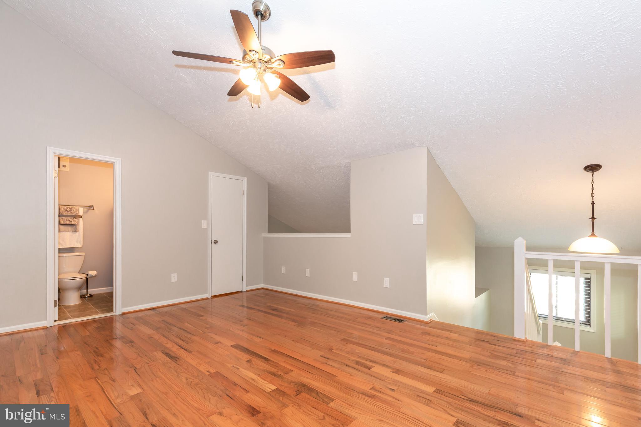 2233 Hunter's Run Drive Reston, VA 20191 - Photo 22 of 50 a view of an empty room with window and wooden floor