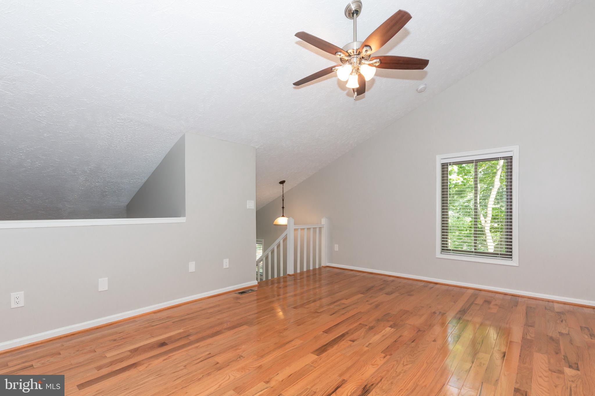 2233 Hunter's Run Drive Reston, VA 20191 - Photo 23 of 50 an empty room with a window and a ceiling fan