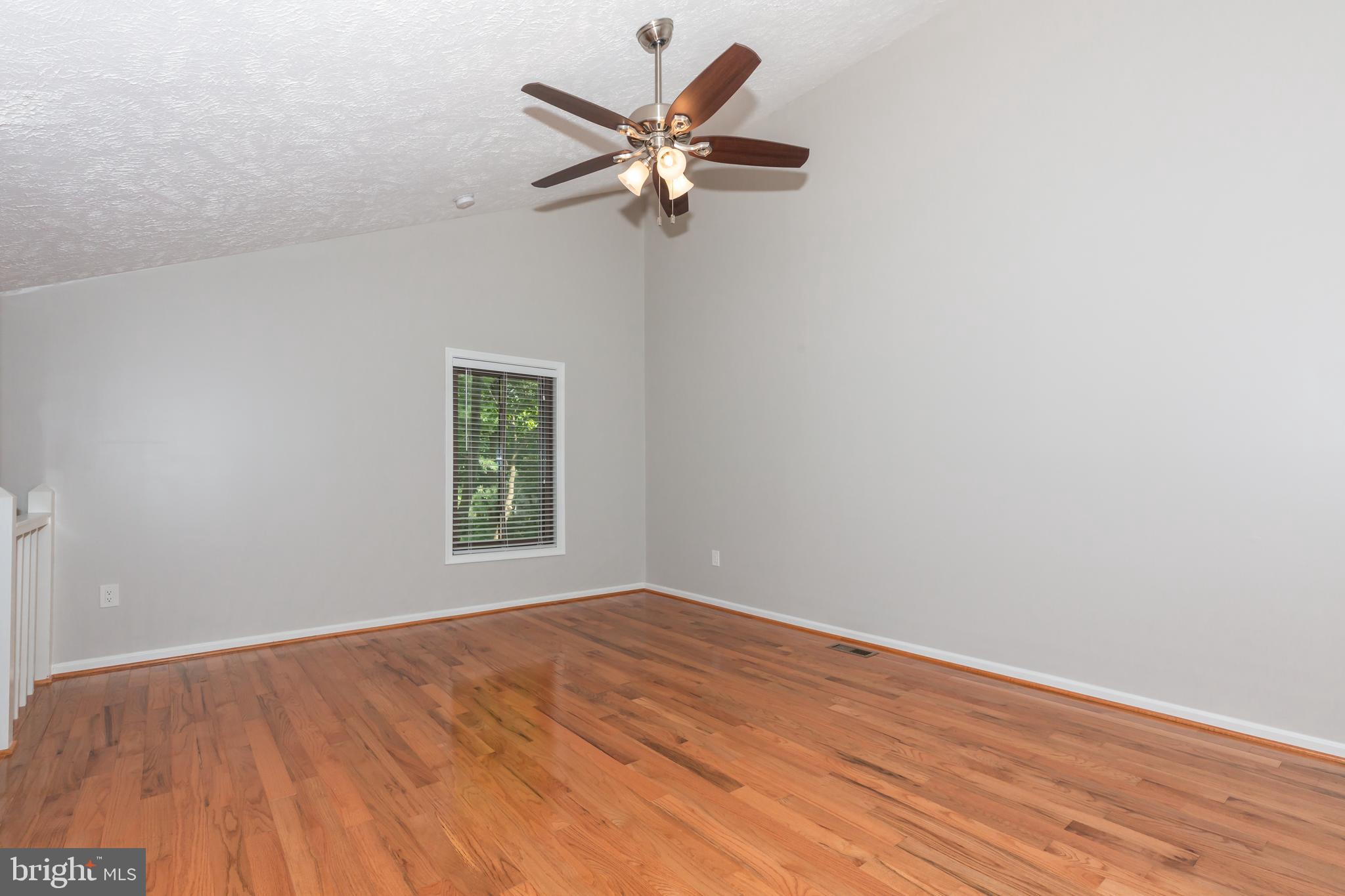 2233 Hunter's Run Drive Reston, VA 20191 - Photo 25 of 50 an empty room with wooden floor fan and windows