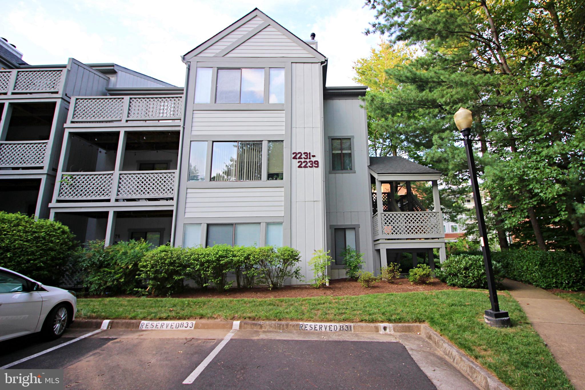 2233 Hunter's Run Drive Reston, VA 20191 - Photo 40 of 50 a front view of a residential apartment building with a yard