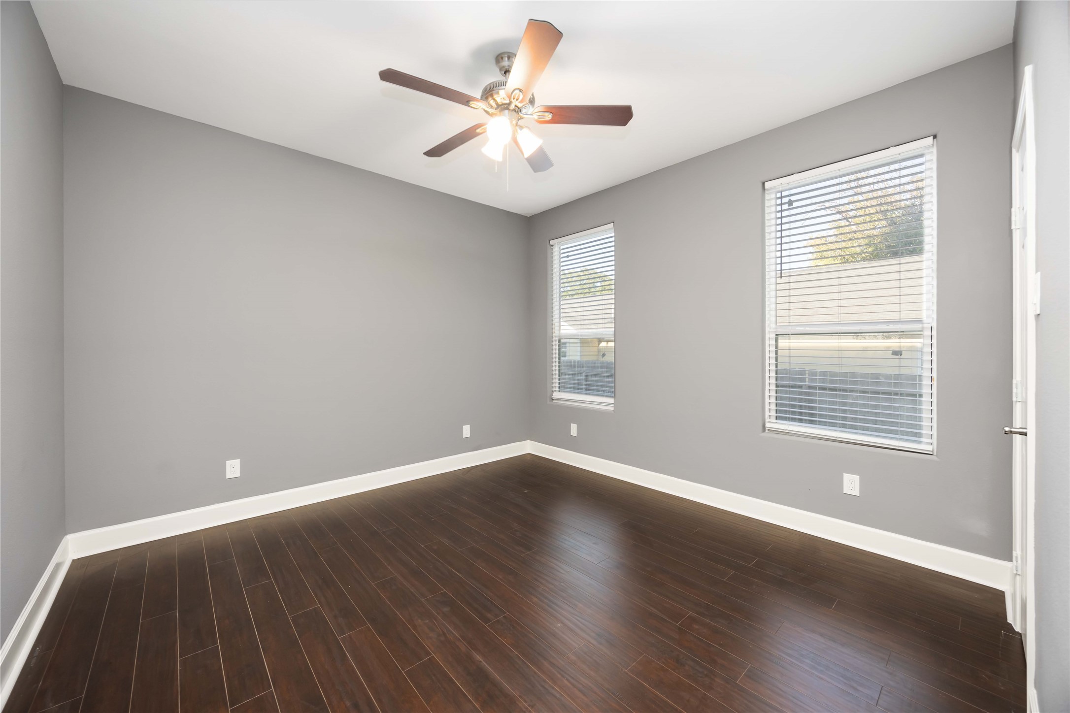 813 Fortune Street Houston, TX 77088 - Photo 12 of 27 an empty room with wooden floor and windows