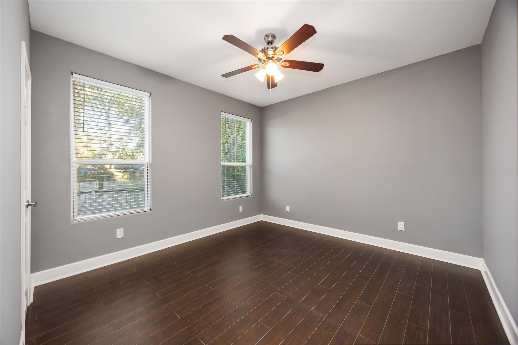 813 Fortune Street Houston, TX 77088 - Photo 15 of 27 an empty room with wooden floor and windows