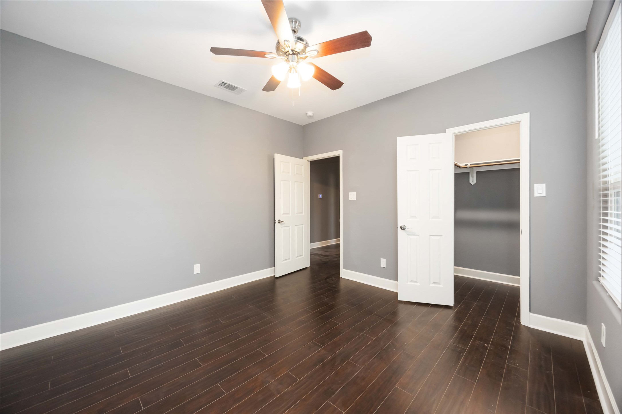 813 Fortune Street Houston, TX 77088 - Photo 16 of 27 an empty room with wooden floor and a ceiling fan