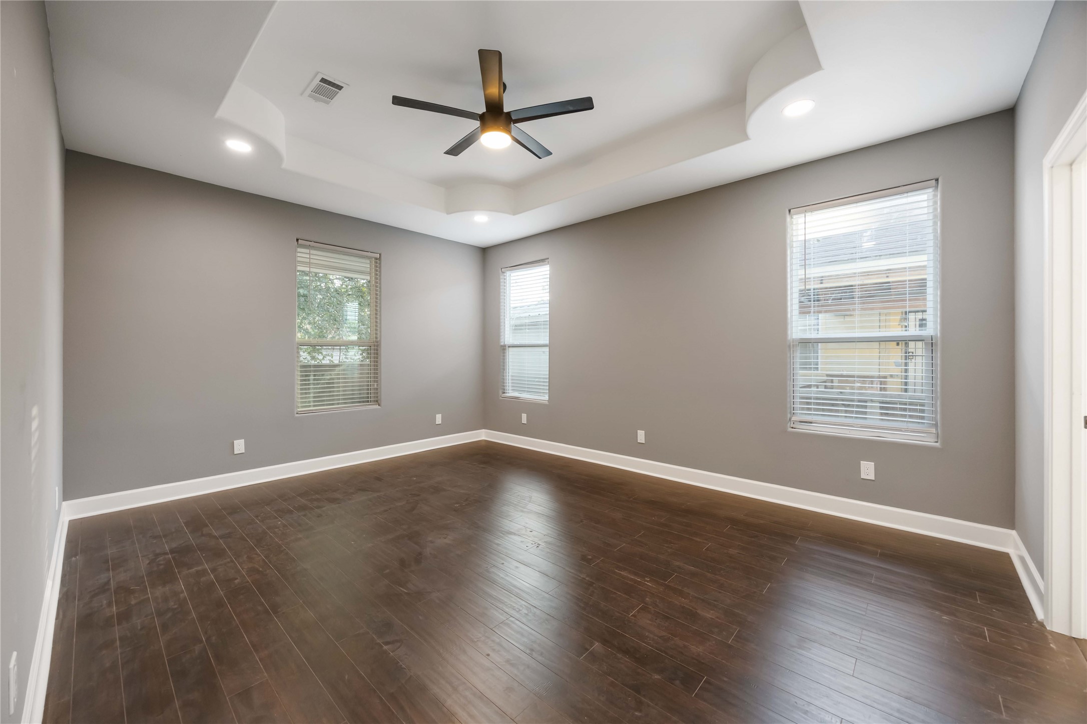 813 Fortune Street Houston, TX 77088 - Photo 17 of 27 an empty room with wooden floor fan and windows