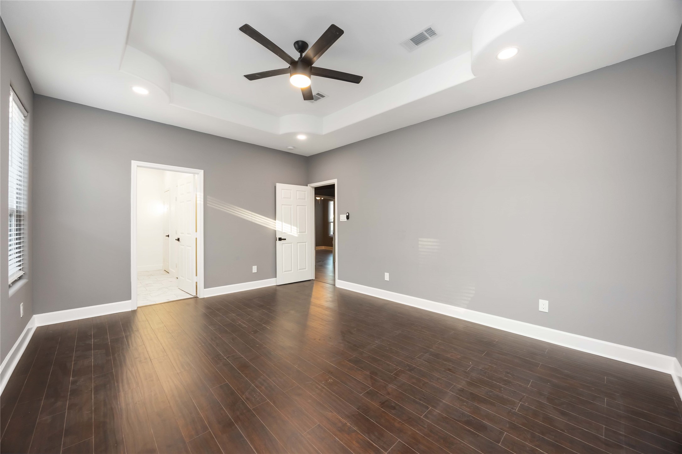 813 Fortune Street Houston, TX 77088 - Photo 18 of 27 an empty room with wooden floor and windows