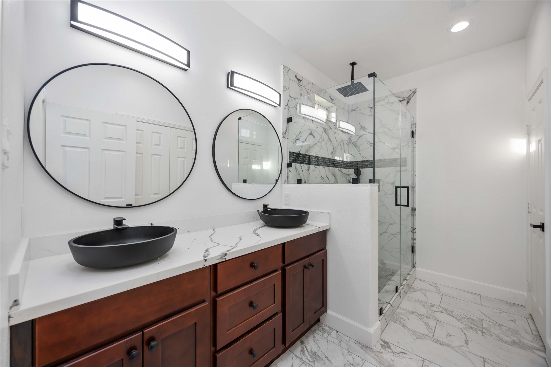 813 Fortune Street Houston, TX 77088 - Photo 19 of 27 a bathroom with a double vanity sink and a mirror