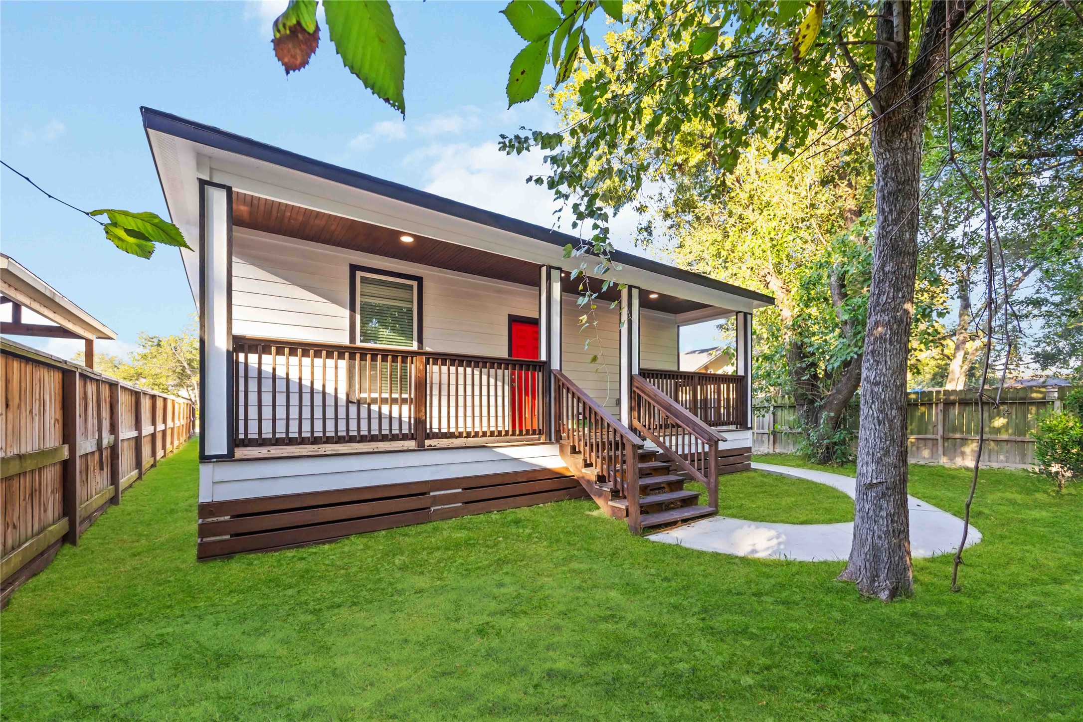 813 Fortune Street Houston, TX 77088 - Photo 26 of 27 a view of a house with a yard deck and a large tree