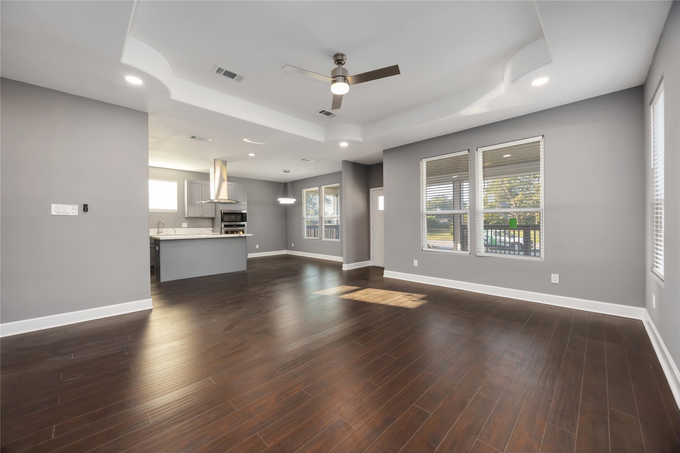 813 Fortune Street Houston, TX 77088 - Photo 6 of 27 a view of an empty room with a kitchen and wooden floor