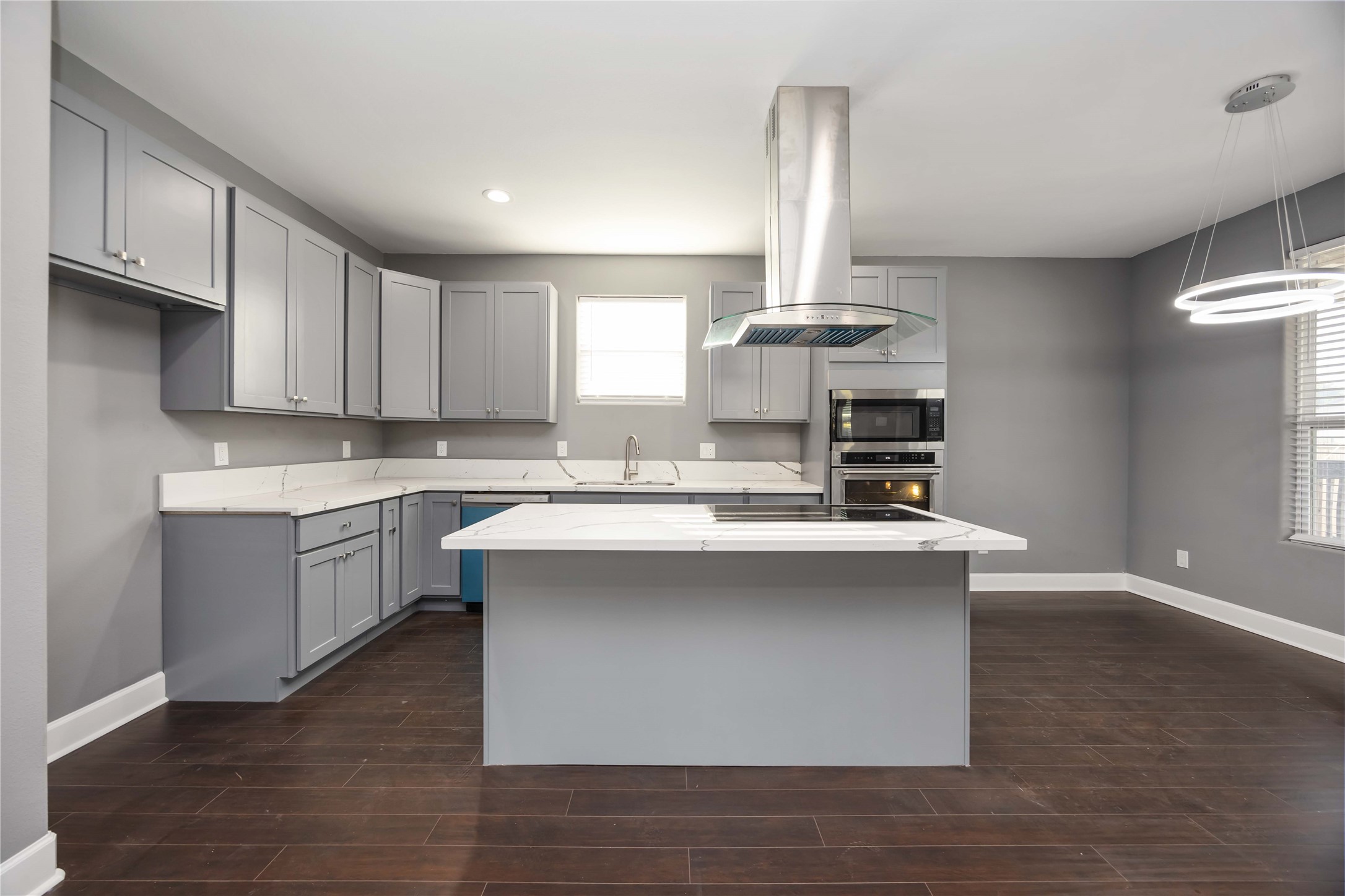 813 Fortune Street Houston, TX 77088 - Photo 7 of 27 a kitchen with stainless steel appliances a sink stove and wooden floor