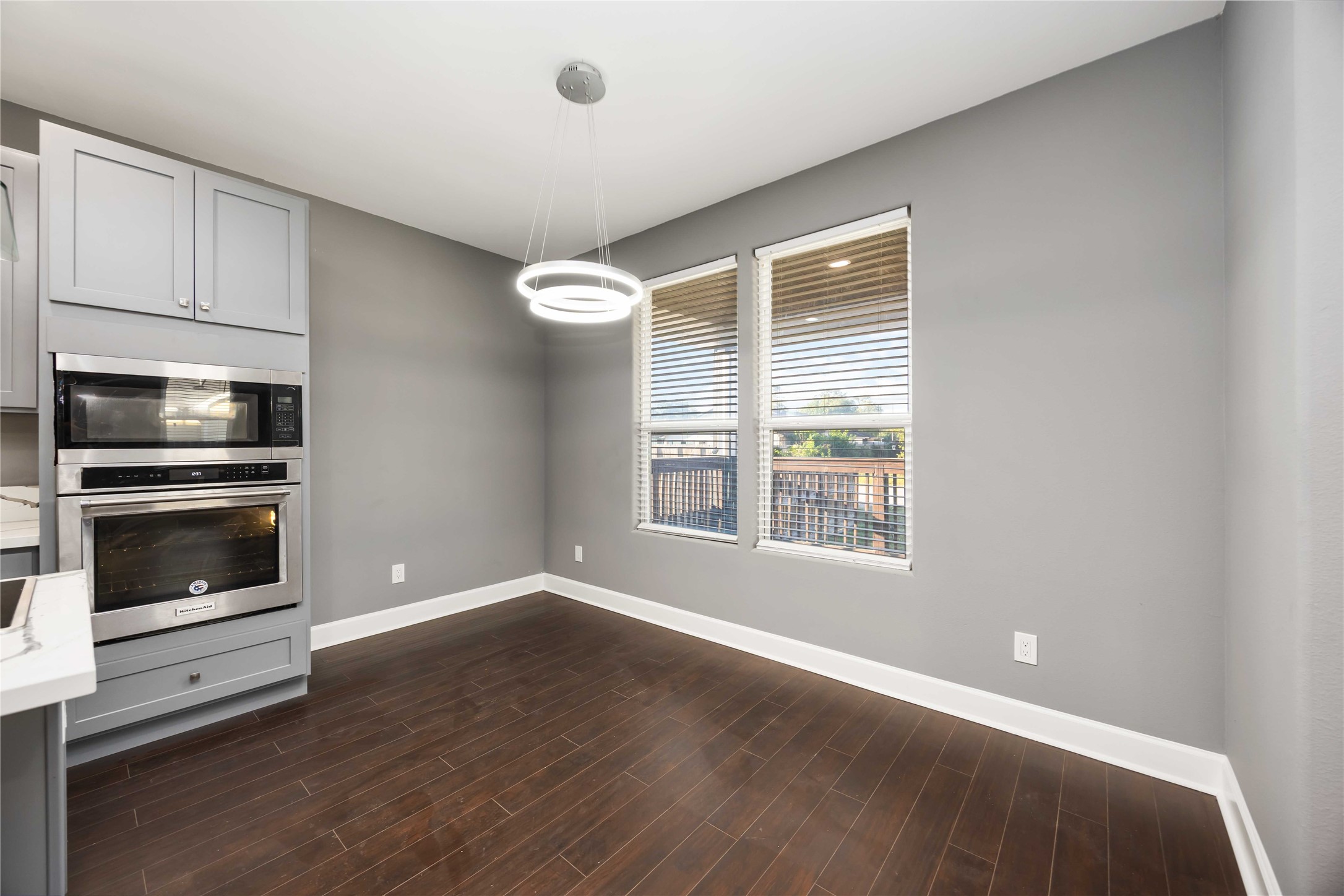 813 Fortune Street Houston, TX 77088 - Photo 10 of 27 a view of an empty room with a kitchen and wooden floor