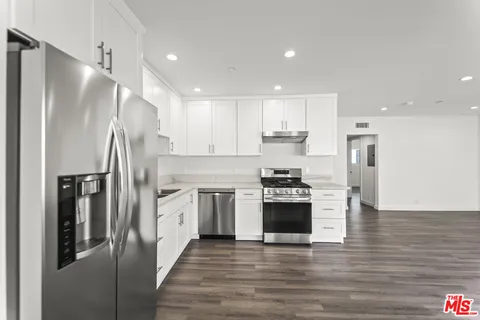 a kitchen with stainless steel appliances a refrigerator sink and stove