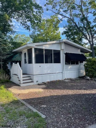 a view of a small house with a yard