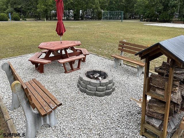 81 Flounder Ocean View, NJ 08230 - Photo 15 of 20 a table and chairs sitting next to a lake