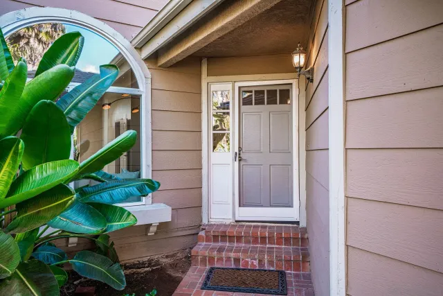 a living room with furniture a rug and white walls