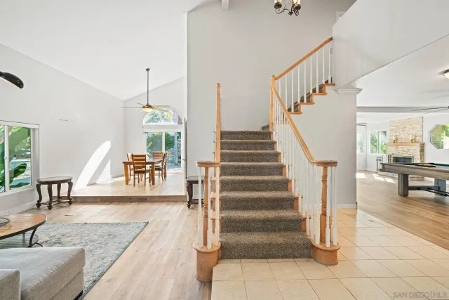 a living room with furniture a rug and a large window