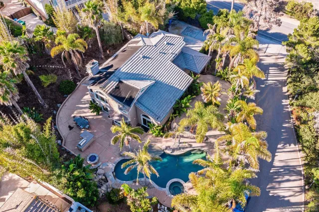 an aerial view of a house with a yard and garden