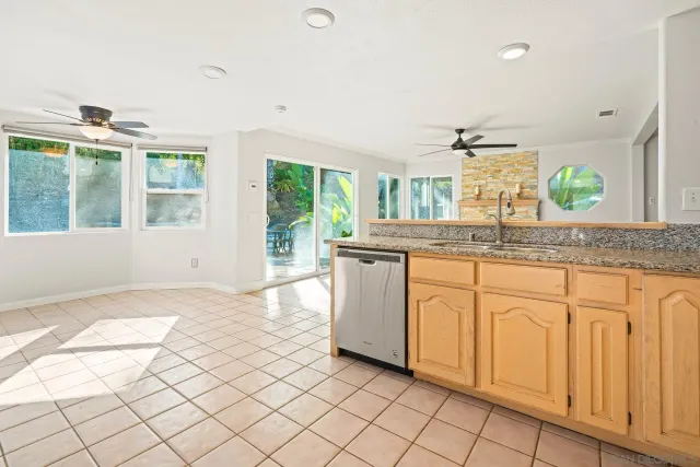 a view of a kitchen with wooden floor and a window