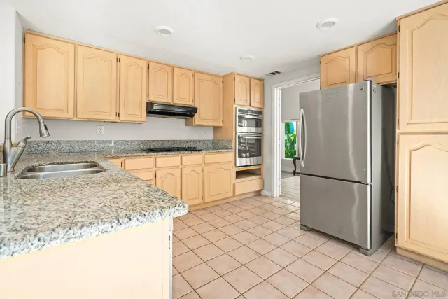 a view of living room with granite countertop furniture a fireplace and a large window