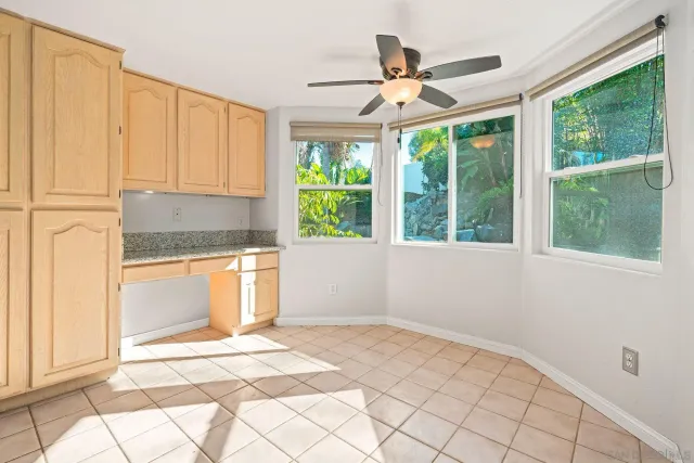 a view of a livingroom with a fireplace a ceiling fan and a fireplace