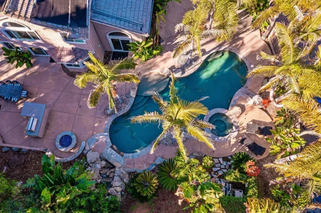 an aerial view of a house with a yard and garden