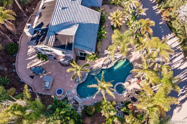 an aerial view of a house with garden space and sitting area