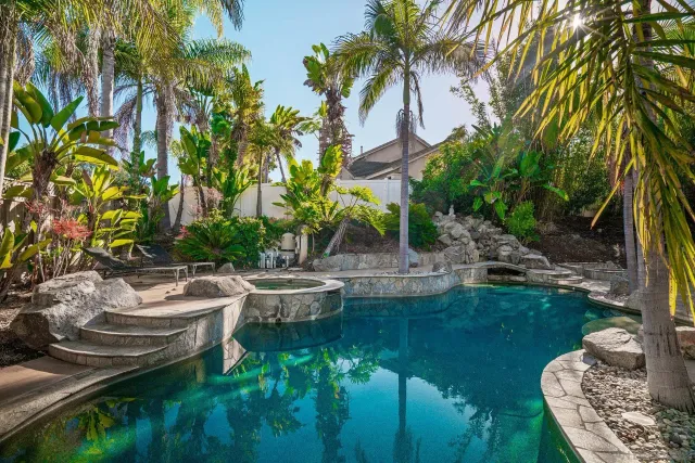 a backyard of a house with table and chairs