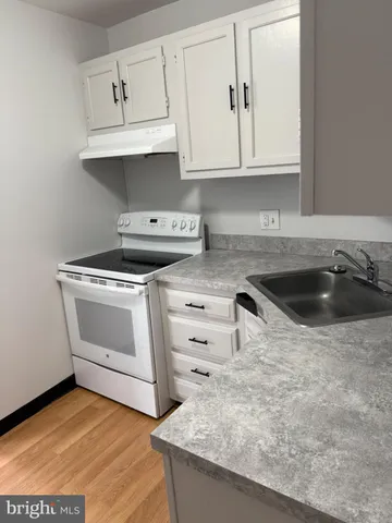 a white toilet sitting next to a shower