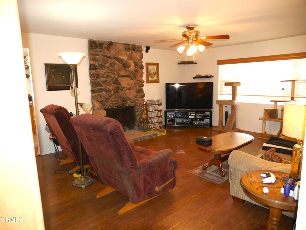 1772 Weston Circle Camarillo, CA 93010 - Photo 13 of 36 a living room with furniture a flat screen tv and a floor to ceiling window