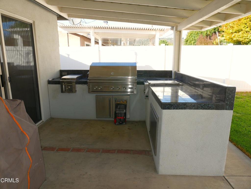 1772 Weston Circle Camarillo, CA 93010 - Photo 19 of 36 a kitchen with granite countertop a sink stove and refrigerator