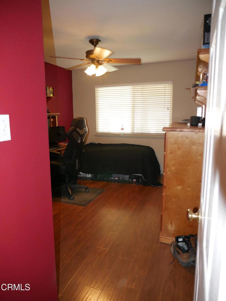 1772 Weston Circle Camarillo, CA 93010 - Photo 25 of 36 a bedroom with a bed and a chandelier