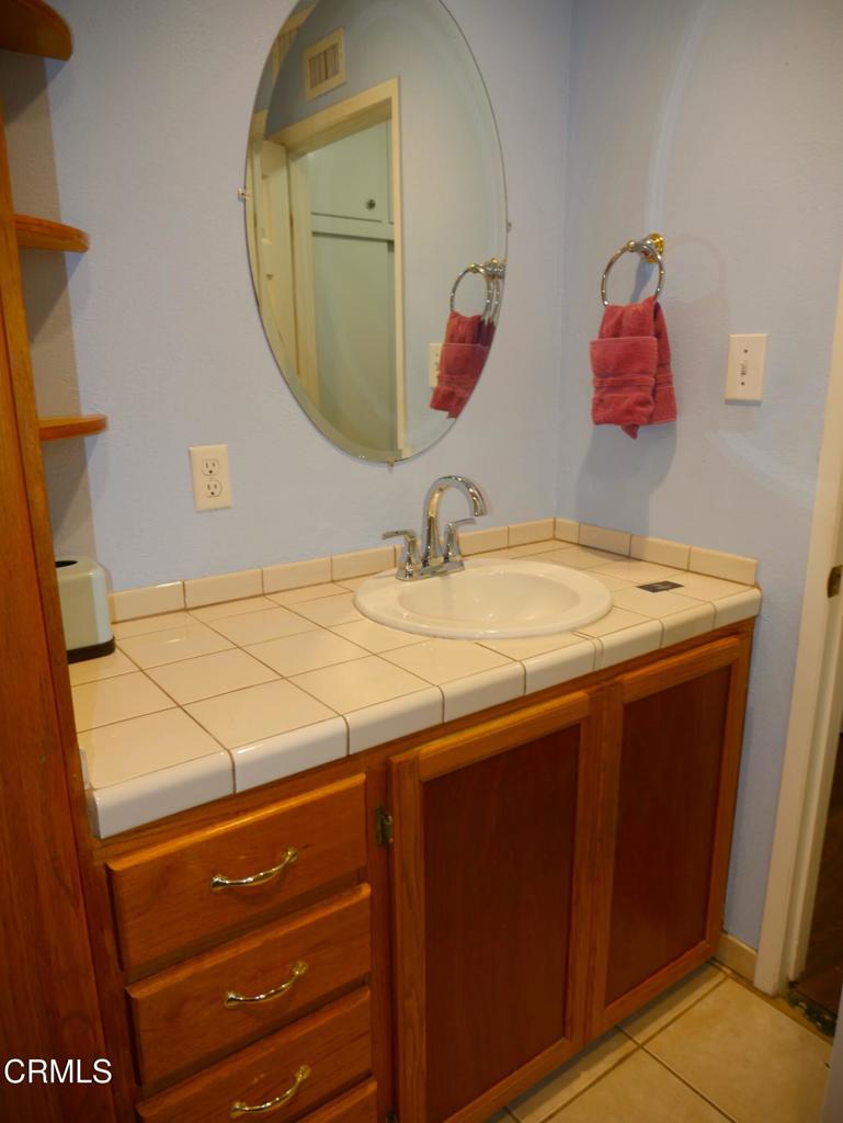 1772 Weston Circle Camarillo, CA 93010 - Photo 33 of 36 a bathroom with a sink vanity and a mirror