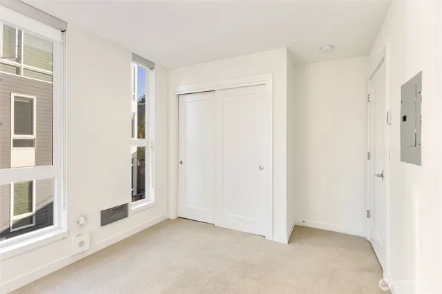 a view of an empty room with brick walls