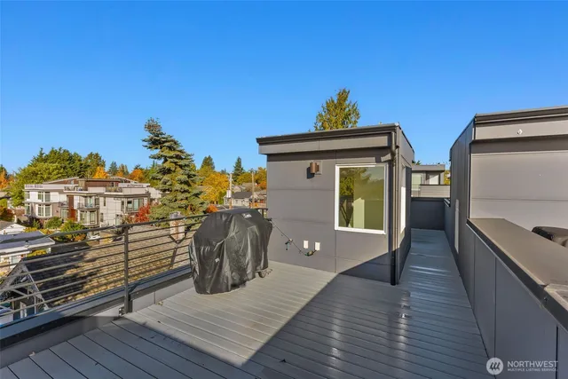 a view of a deck with wooden floor and a potted plant