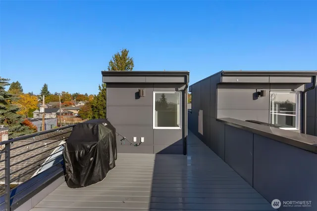 a view of a balcony with wooden floor and iron fence