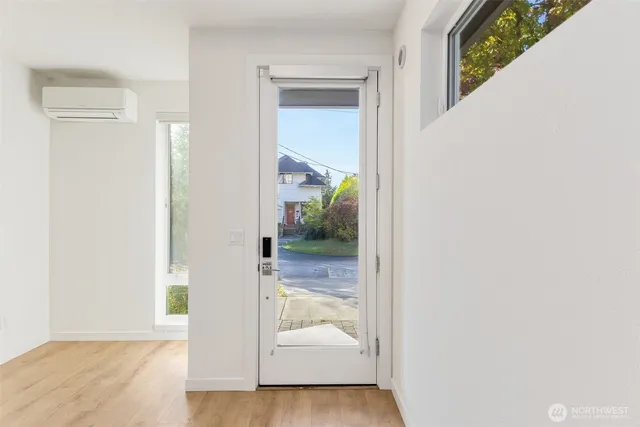 a view of a hallway with white walls and stairs